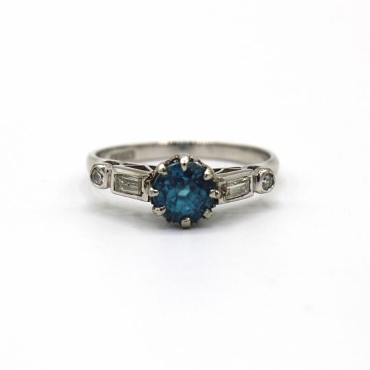 Platinum Claw Set Blue Zircon Ring With Diamond Set Shoulders