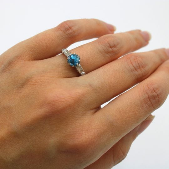 Platinum Claw Set Blue Zircon Ring With Diamond Set Shoulders